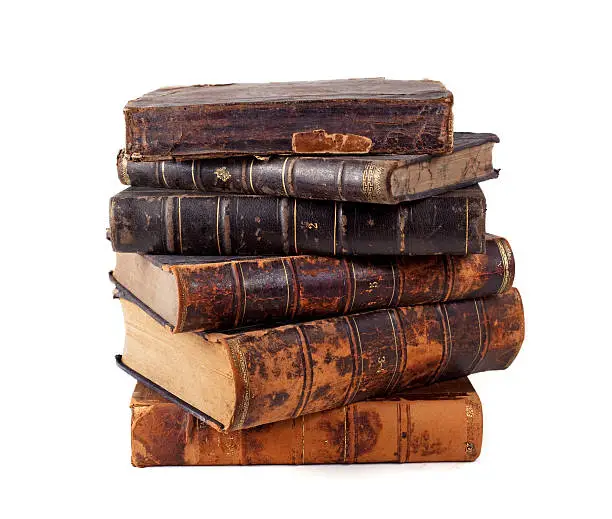 "A stack of leather-bound antique books, isolated on white."