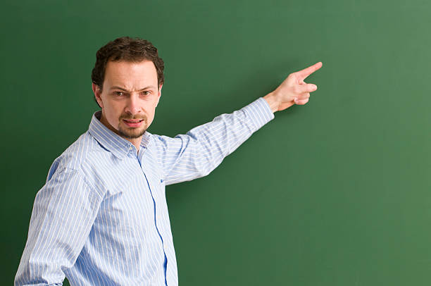 istock angry teacher directing at blackboard 183534135