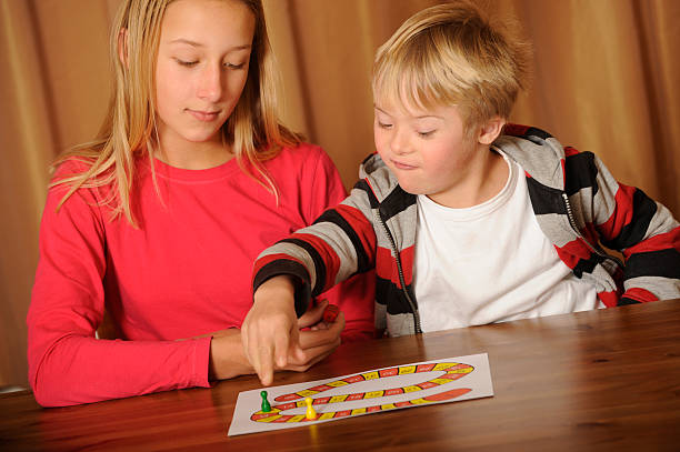 istock Sister and brother are playing a board game 183534242