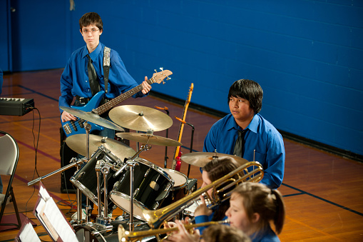 A highschool band playing in the gym