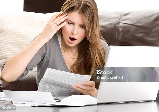 Stressed Woman Looking At Bills Stock Photo - Download Image Now - Blond Hair, Emotional Stress, Laptop