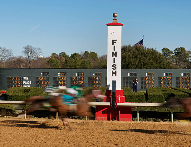 Rapid motion photo of horses at a race track finish line The finish line at a horse racing track in Hot Springs, Arkansas. finish line photos stock pictures, royalty-free photos & images