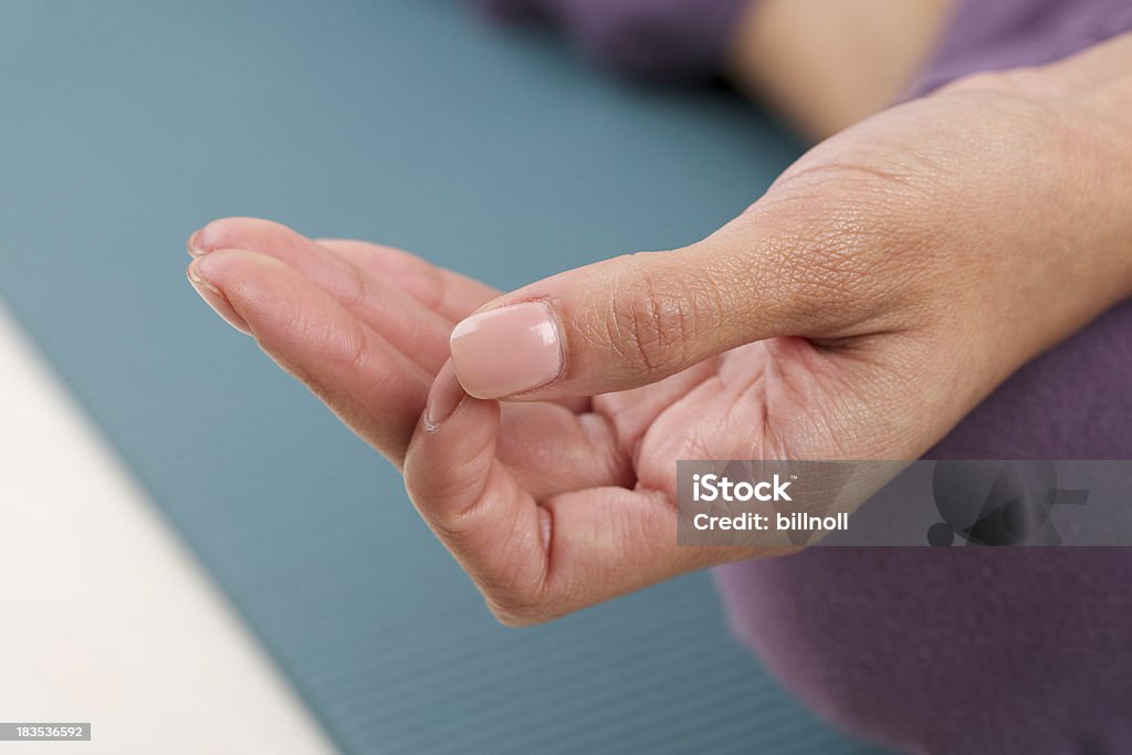Close up view of female hand with yoga gesture "Studio photo of female hand with yoga gesture called a guyan mudra. According to yoga practice, this position symbolizes knowledge and ability. Selective focus on fingers.Please view more photos here:" Beauty Stock Photo