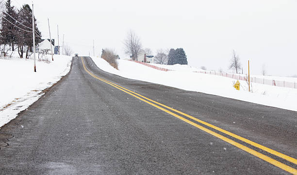 istock Car Approaching on Rural Winter Road Highway 183537446