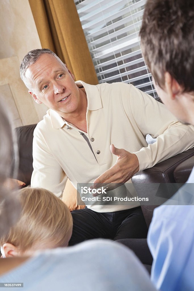 Avô explicar algo para seu filho em casa - Foto de stock de Conselho royalty-free