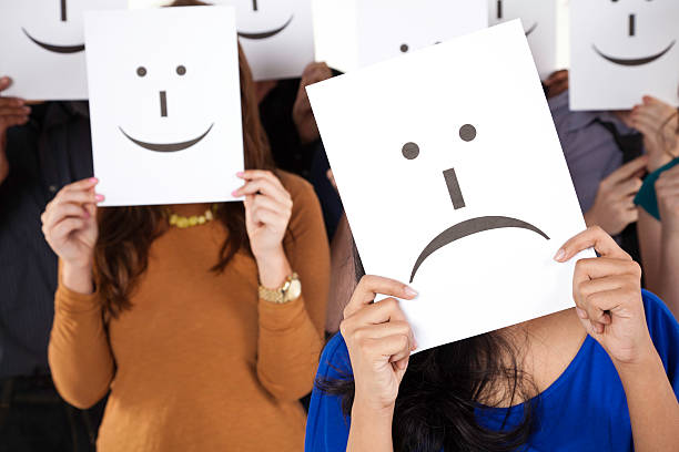 istock Sad Face Emoticon Card Surrounded by Happy Faces 183537838