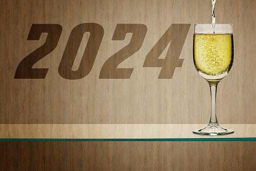 2024 Happy New Year on Wood panel and Glass shelf with White wine