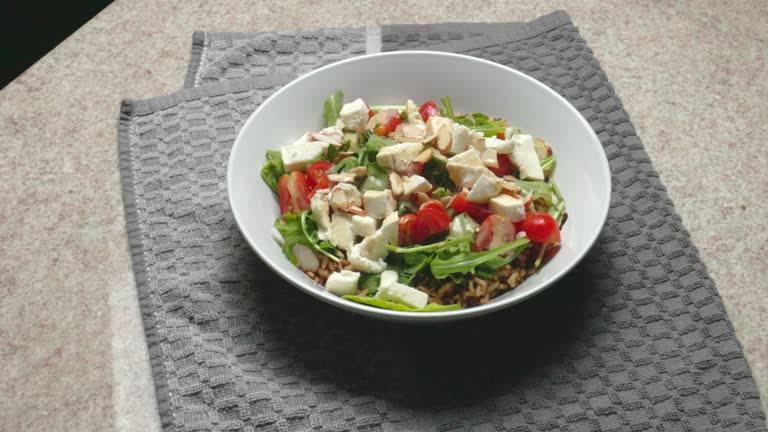 Tomato Caprese Grain Bowl with Fresh Mozzarella,  Arugula, Creamy Balsamic Dressing and Almonds