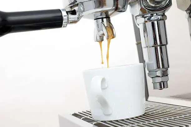 Close-up of an espresso machine at work.