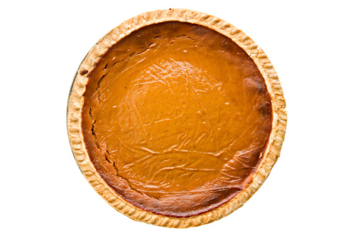 Whole pumpkin pie isolated and overhead view.