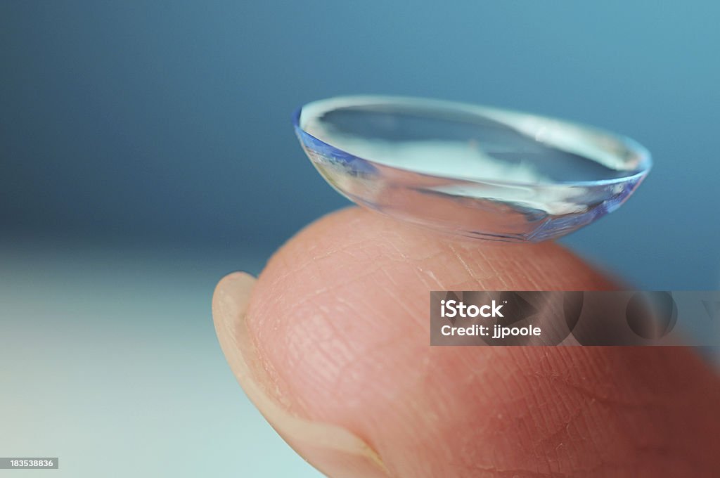 Contact Lens on blue background "Fresh contact lens, ready to wear" Contact Lens Stock Photo