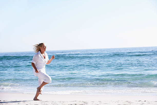 istock Senior Woman Running along Beach 183538931