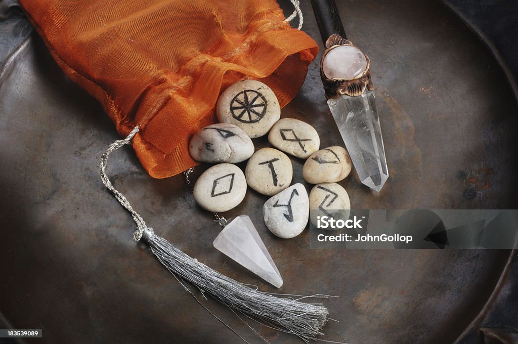 Divination Tools "Rune stones, wand, and pendulum, all tools for divination." Runes Stock Photo