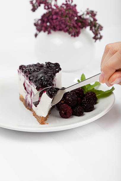 Eating a fresh cheesecake with raspberries