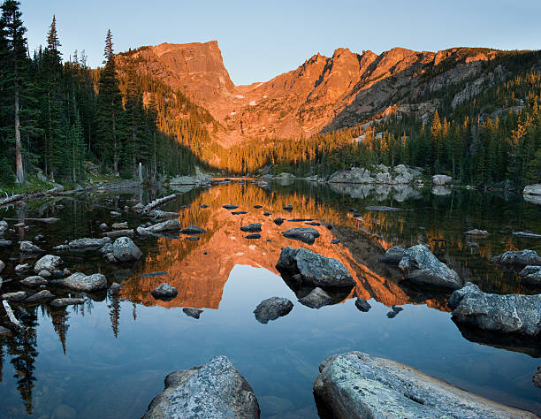 Dream Lake Sunrise Reflection of Hallet Peak "Sunrise lights up Hallet Peak with a warm alpenglow.  In the foreground, a calm Dream Lake perfectly reflects the scene." rocky mountain national park photos stock pictures, royalty-free photos & images