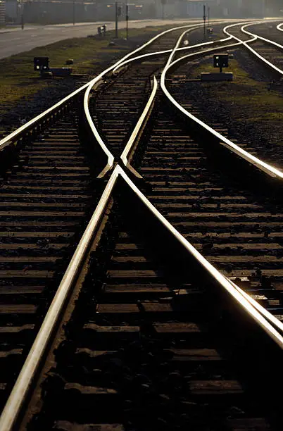"Railroad tracks and junctions, backlit shot."