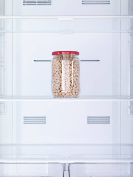 istock Chickpeas in a jar on the empty refrigerator shelf. No people. 1835416051
