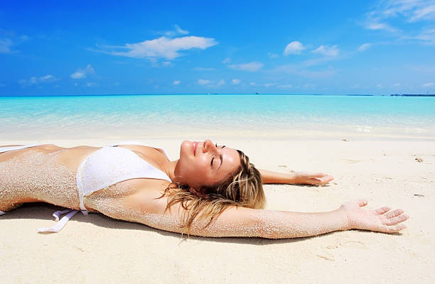 istock Beautiful girl lying on tropical beach. 183542041