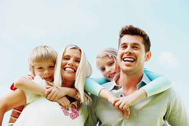 istock Cheerful family having fun against sky 183542315