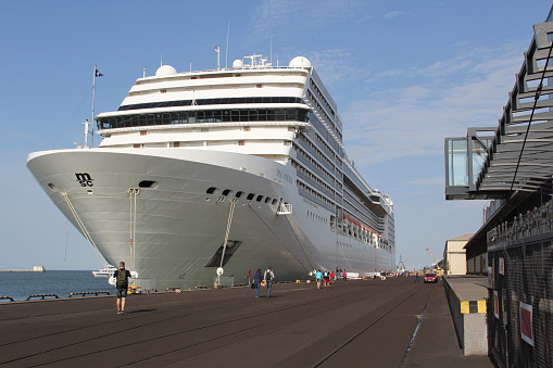MSC Poesia cruise ship in the port of Gdynia, Poland. Entering the port and mooring at the French Quay.