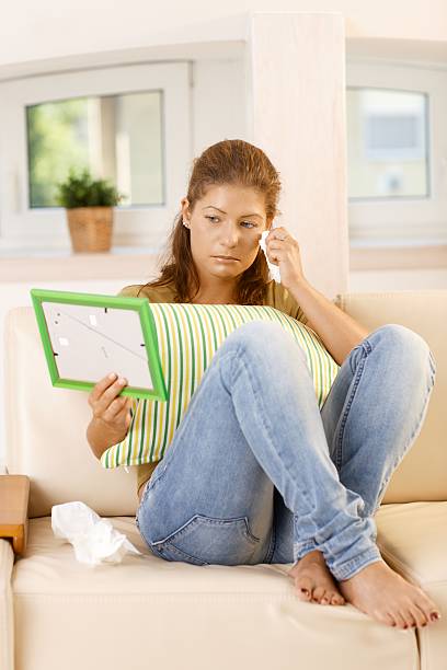 istock Crying young woman looking at a framed picture 183542834