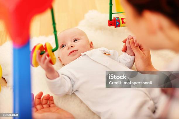 Baby Using Fine Motor Skills To Play Stock Photo - Download Image Now - Baby - Human Age, Looking Around, 2-5 Months