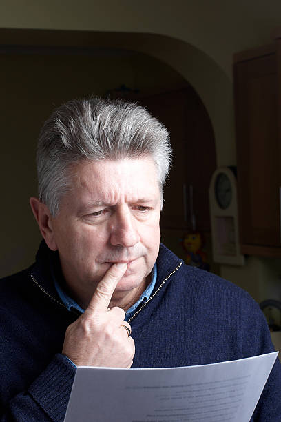 istock Mature man reading worrying news letter 183545222