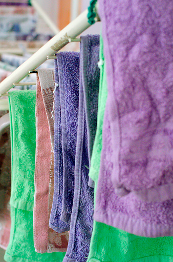 Washed clothes are dried on the dryer at home. Close-up, vertical photograph.