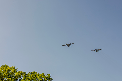 View of two planes flying over city.