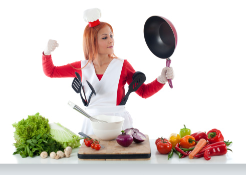 A chef holding vegetables.