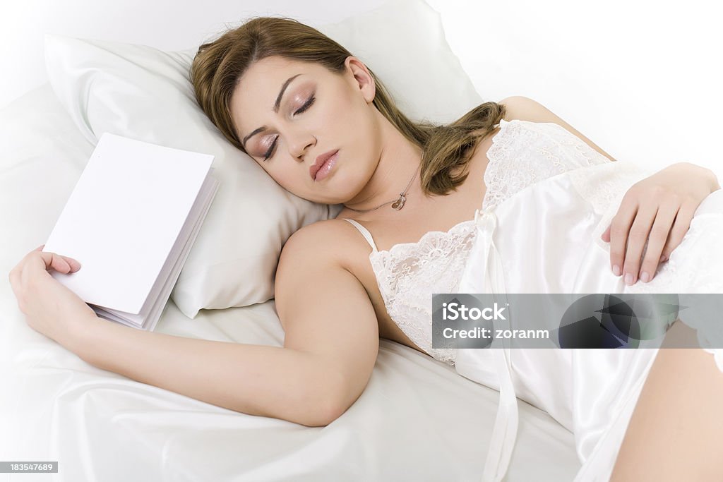 Sleeping Beautiful woman sleeping with a book in her hand Adult Stock Photo