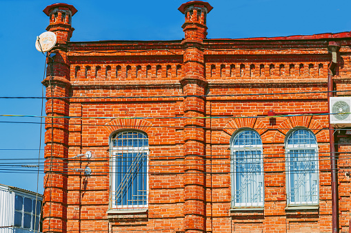 An old brick building with windows.