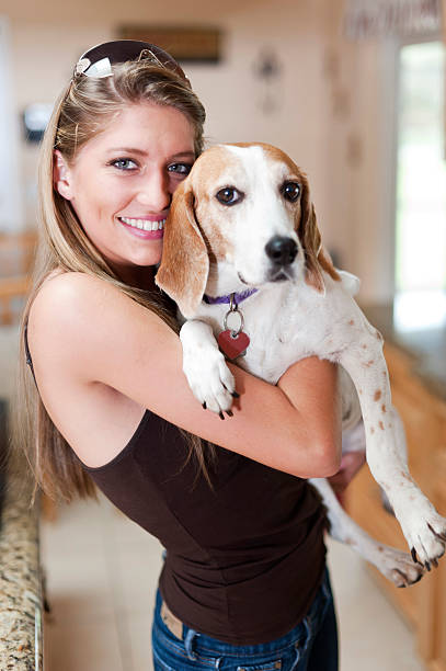 istock Beautiful woman holding her dog 183549813