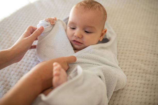 istock Adorable baby boy wrapped in a white towel after bath. 1835504063