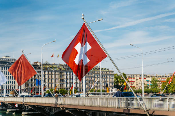 Mont Blanc bridge (The Pont du Mont-Blanc) with Swiss flag over Rhone river in Geneva, Switzerland.