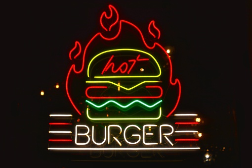 Russia, St. Petersburg - December 2, 2023: LED sign hot burger on a black background
