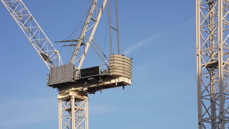 Construction site tower crane slewing.