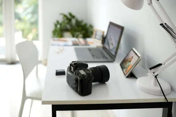 Digital camera on desk of photographer in his home office