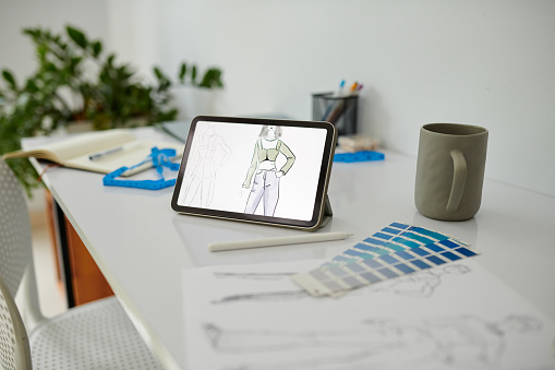 Sketch on digital tablet of fashion design student