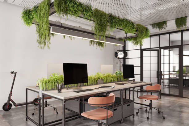istock Coworking office desk with many computers in eco-friendly office 1835563311