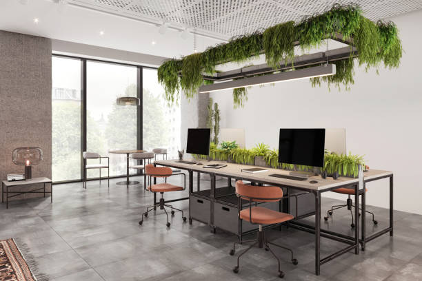 istock Coworking office desk with many computers in eco-friendly office 1835563319