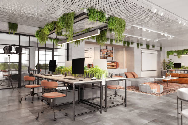 istock Coworking office desk with many computers in eco-friendly office 1835563321