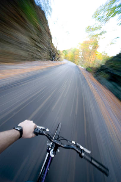 Cycling along a trail in the Fall stock photo