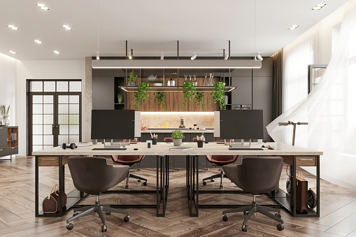 Open plan coworking interior with many desktop computers and kitchen in the background. Daylight render.