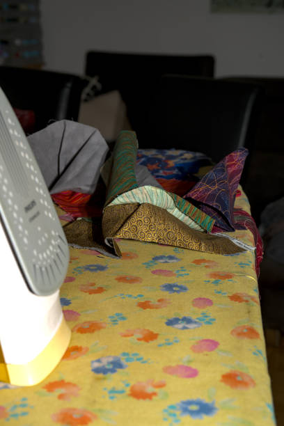 istock sewing table with drappery material and many equipement in disorder 1835592238