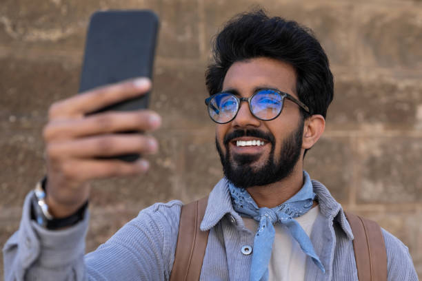 istock Smiling young man making pictures on a telephone 1835594430