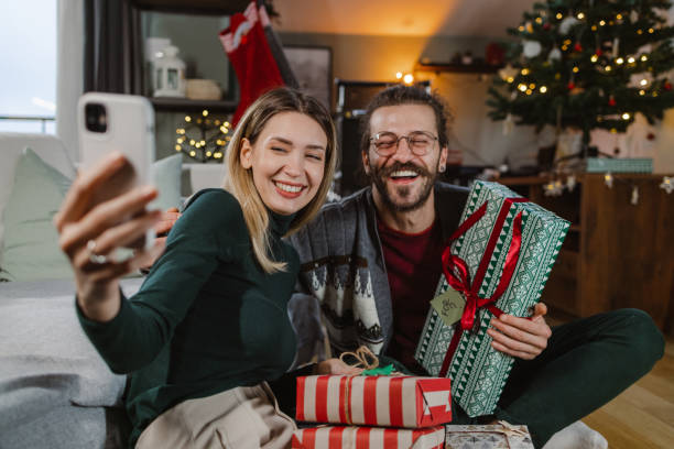 istock Lovely couple taking a selfie on a Christmas day 1835597726