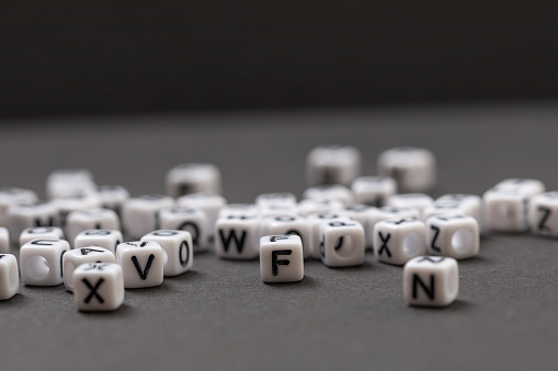 Small white cubes with the letters of the alphabet on them.