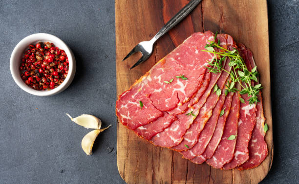 istock Dried Turkish Pastrami Slices On Black  Background 1835604573