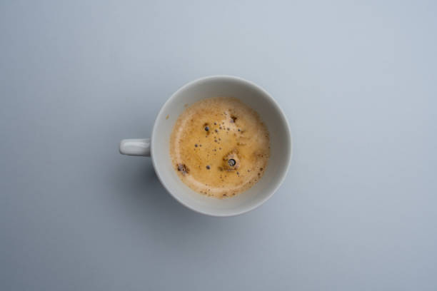 istock Frothy coffee in a porcelain cup on gray background 1835607280